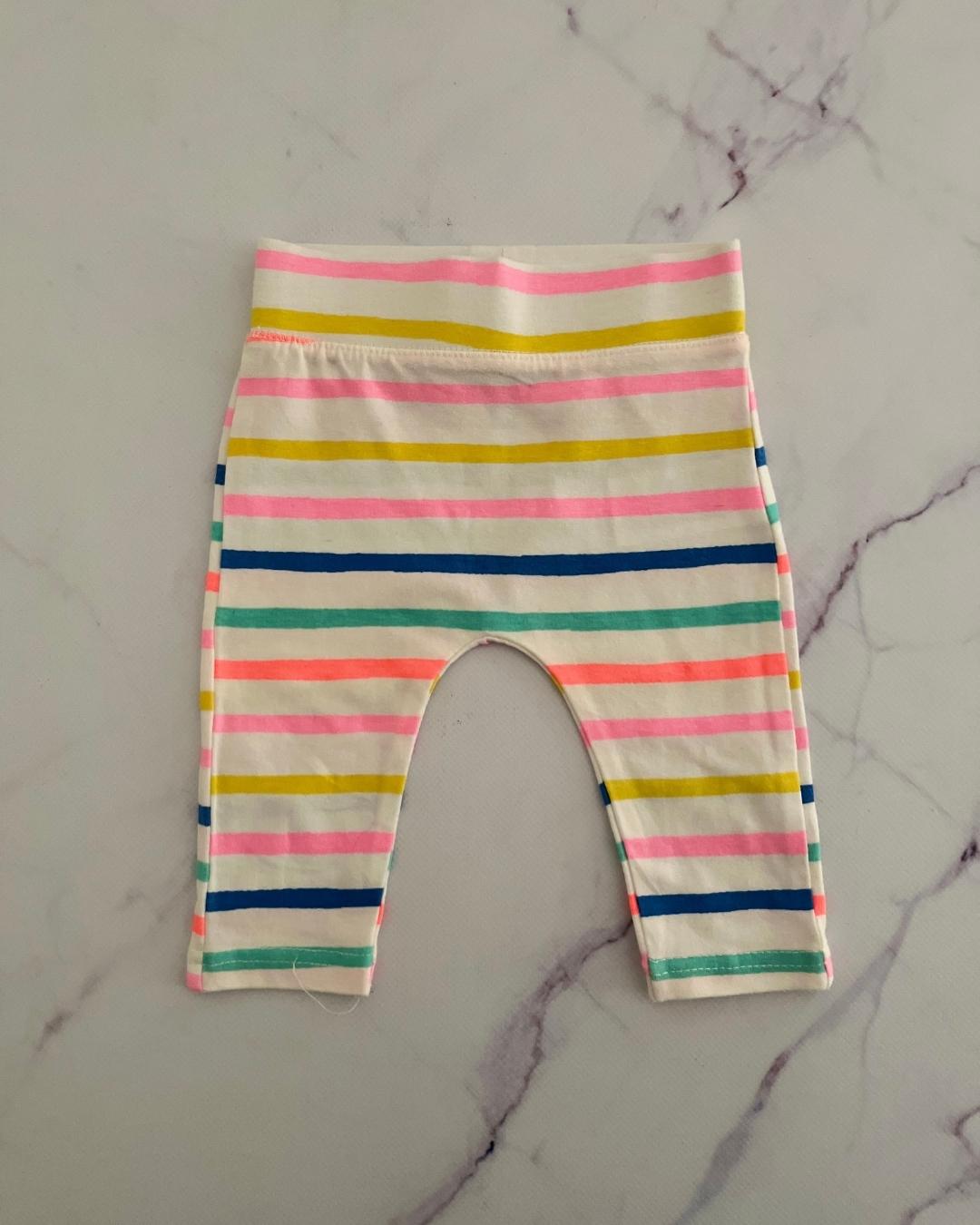 Cotton On white pants with pink, yellow, blue, green and orange stripes 0/3M