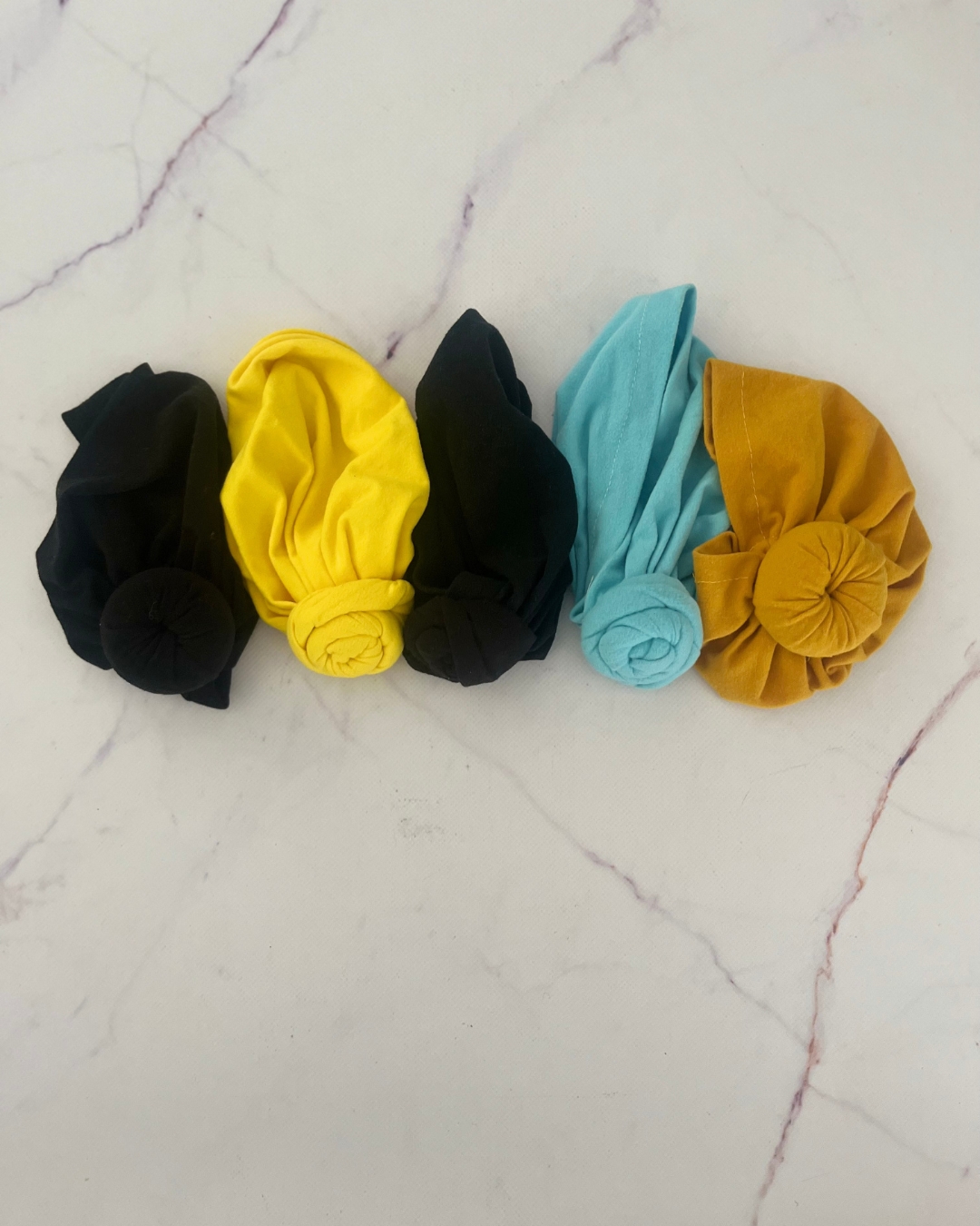 Assorted headscarves in yellow, black(2), blue and mustard