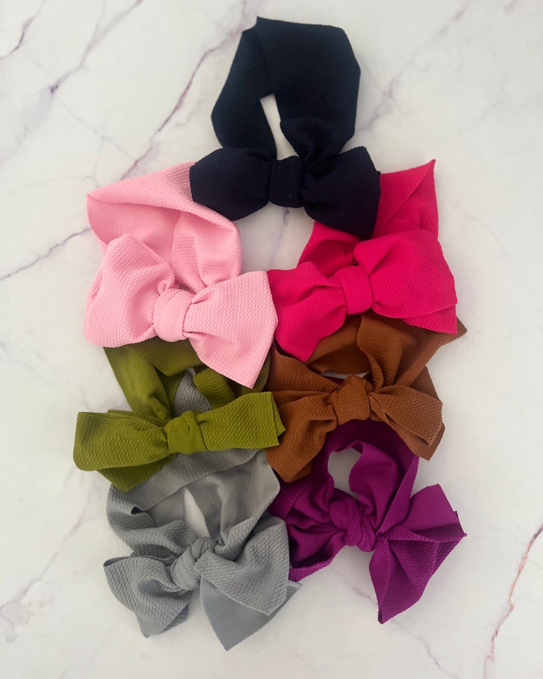 Assorted bow headbands in green, blue, brown, navy, pink, purple and fuschia pink